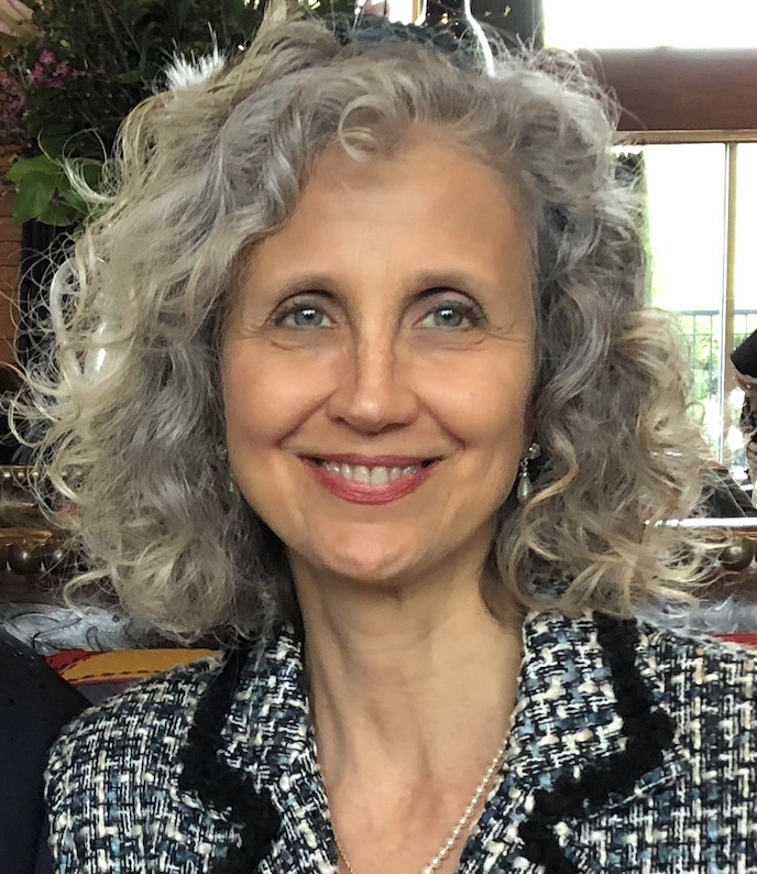 A person smiling for the camera Description automatically generated