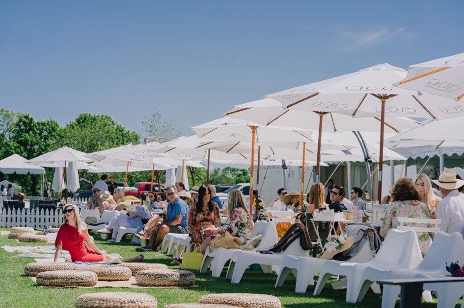 A group of people sitting outside under umbrellas
Description automatically generated with low confidence