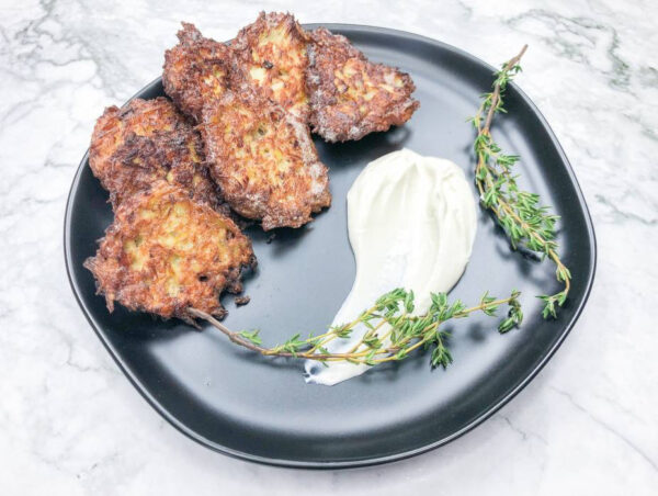 A plate of food on a marble surface Description automatically generated