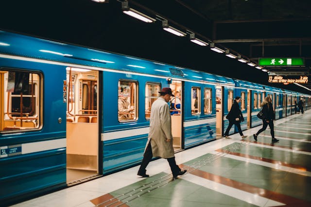 People exiting a blue subway train