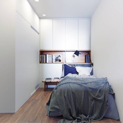 A cozy and charming little bedroom that makes good use of the space offered with a small bed, shelving, and tiny table.