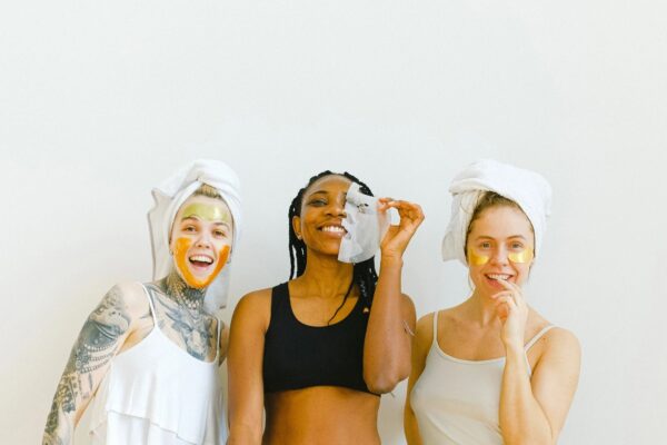 Three women with various skincare