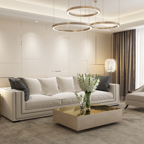 A modern living room with a white chair and sofa, mirrored coffee table, and a statement lighting fixture.